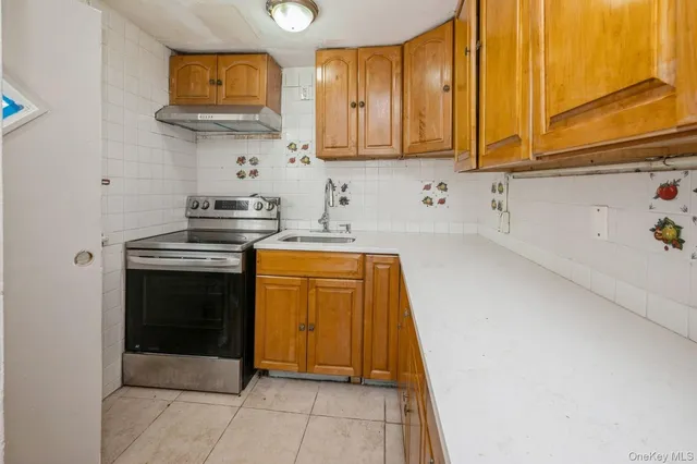 a kitchen with stainless steel appliances a stove a microwave and cabinets