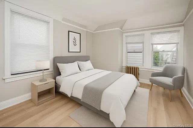 a bedroom with a bed and a large window