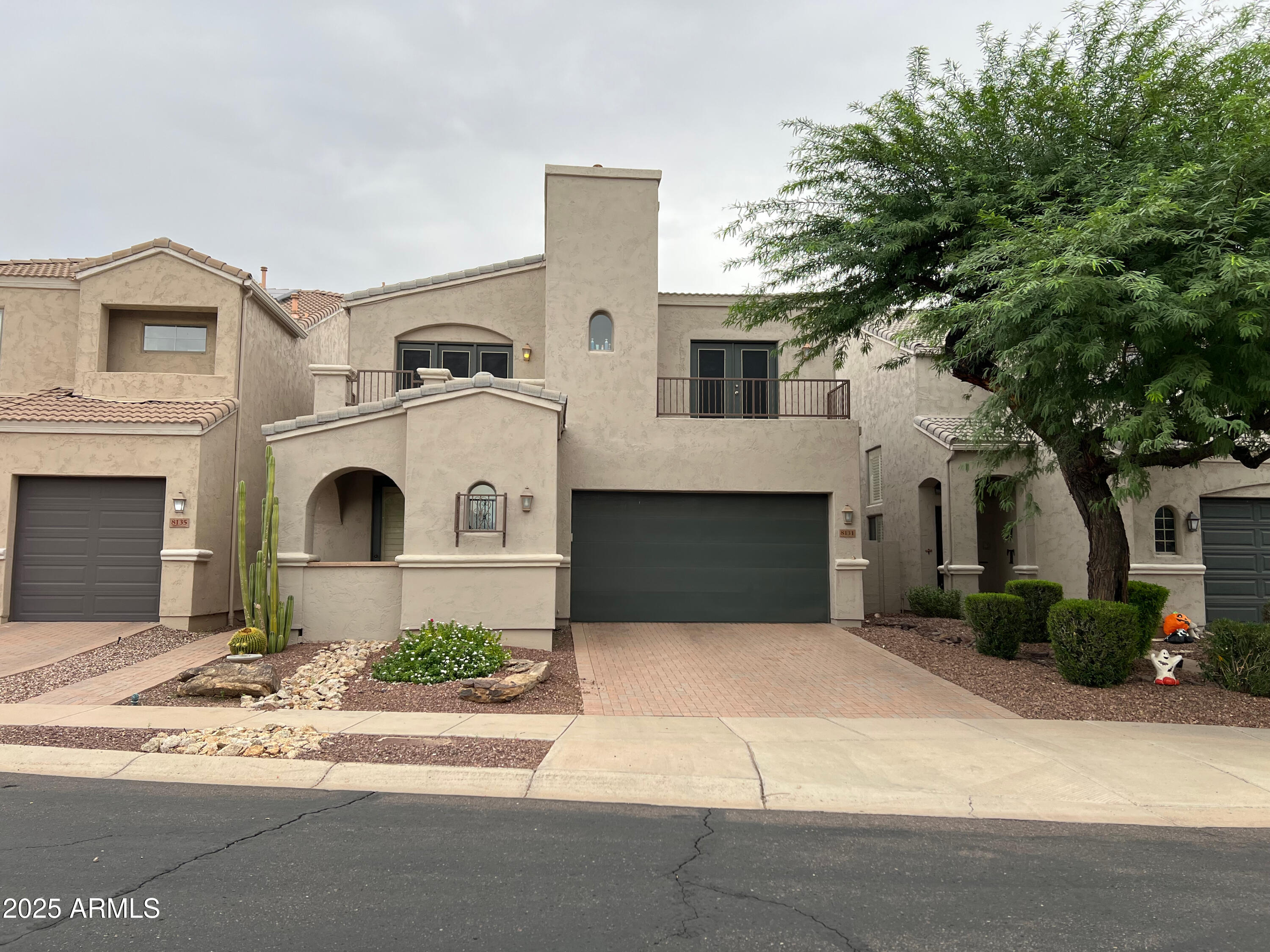 8131 North 13th Way Phoenix, AZ 85020 - Photo 1 of 25 a front view of a house with a yard and garage
