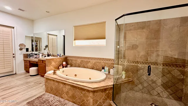 a bathroom with a tub a sink and a mirror