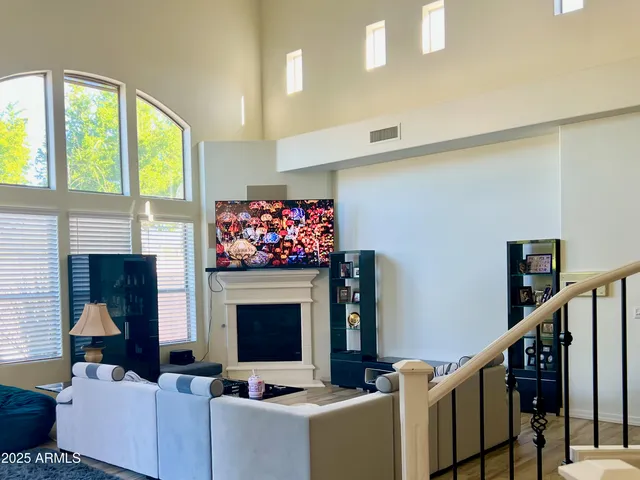 a living room with furniture a fireplace and a flat screen tv