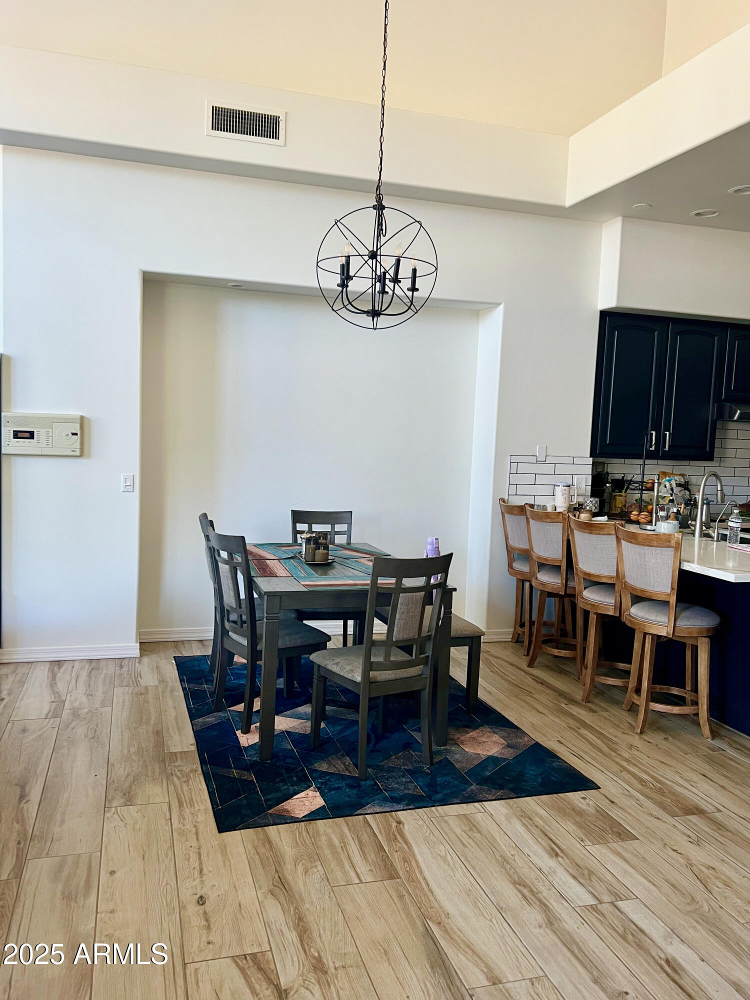 8131 North 13th Way Phoenix, AZ 85020 - Photo 7 of 25 a view of a dining room with furniture wooden floor and chandelier