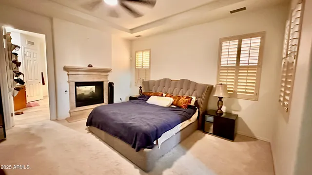 a bedroom with a bed and a fireplace