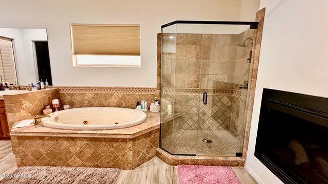 a bathroom with a tub a sink and a mirror