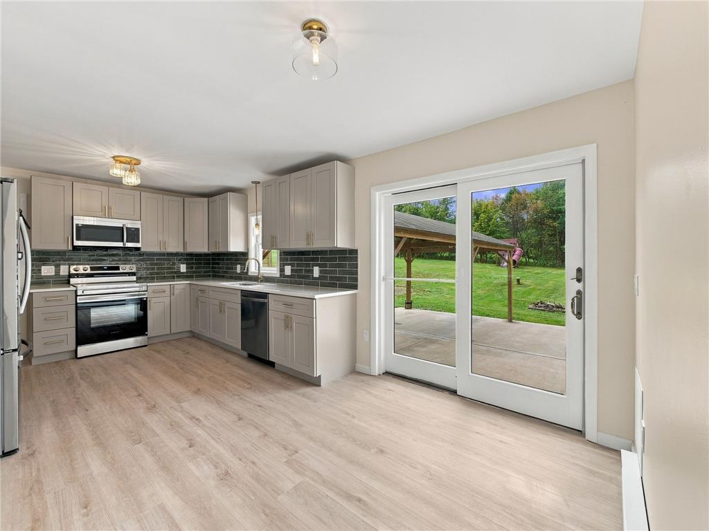 90 Gun Club Road Palmerton, PA 18071 - Photo 27 of 58 Sliding glass doors open from this updated kitchen to a spacious patio and backyard.