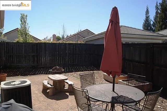 a view of a chairs and table in patio