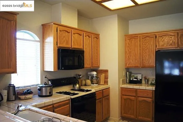a kitchen with a sink cabinets and a window