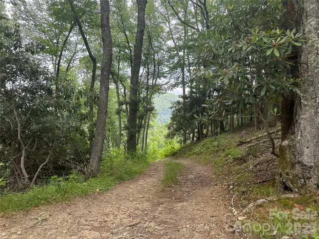 a living room with furniture a large window and a chandelier