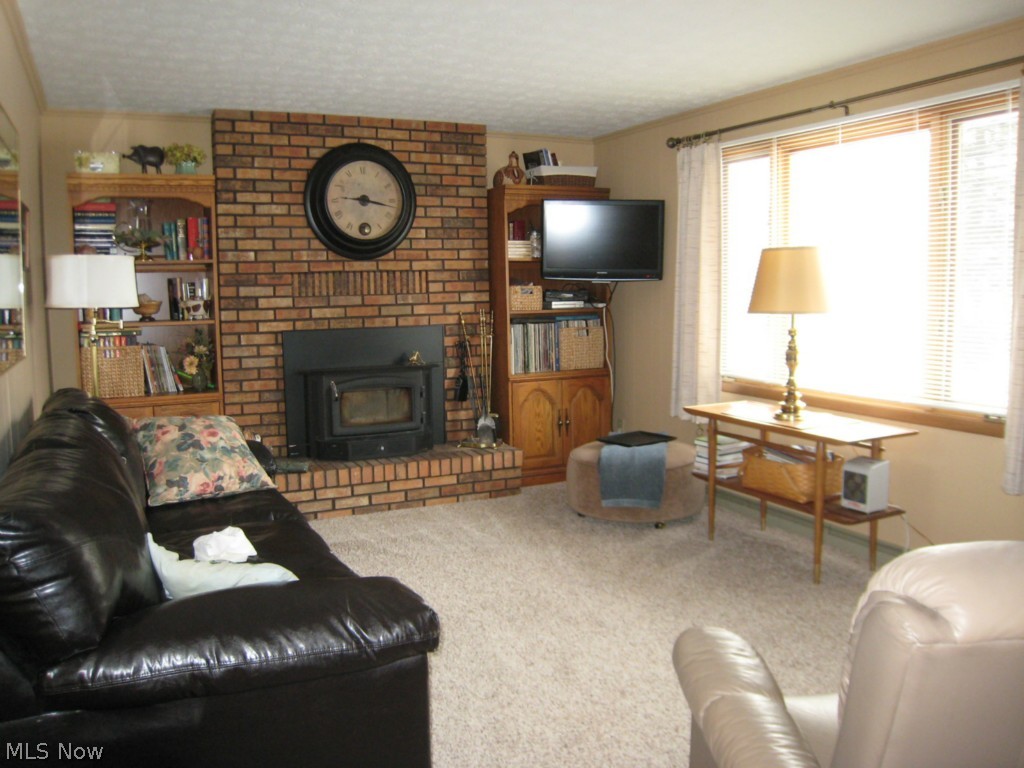 3050 Pontius Road Uniontown, OH 44685 - Photo 5 of 12 FIRST FLOOR FAMILY ROOM WITH WOOD BURNER INSERT