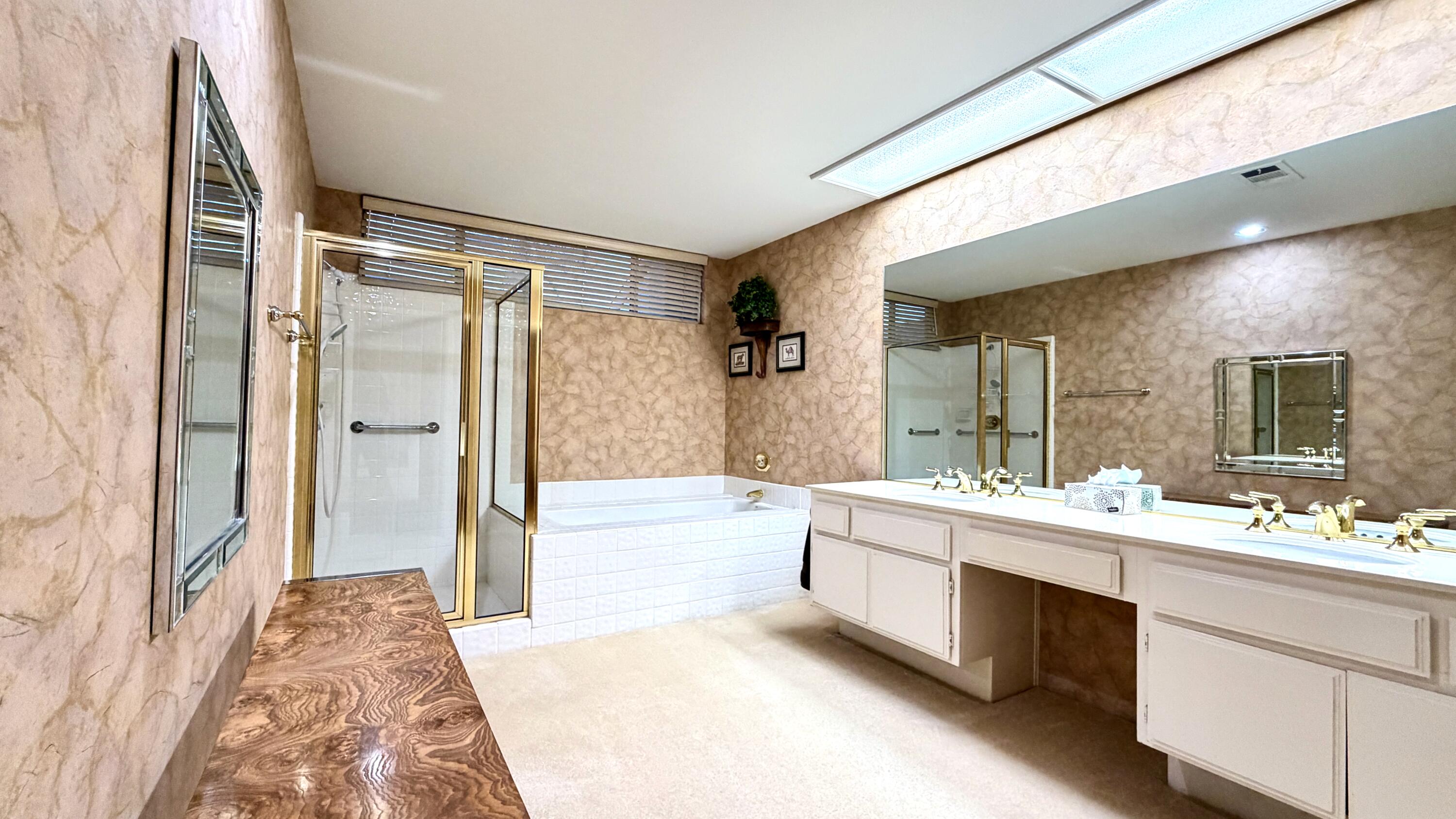 59 Oak Tree Drive Rancho Mirage, CA 92270 - Photo 12 of 22 a bathroom with a tub sink shower and mirror