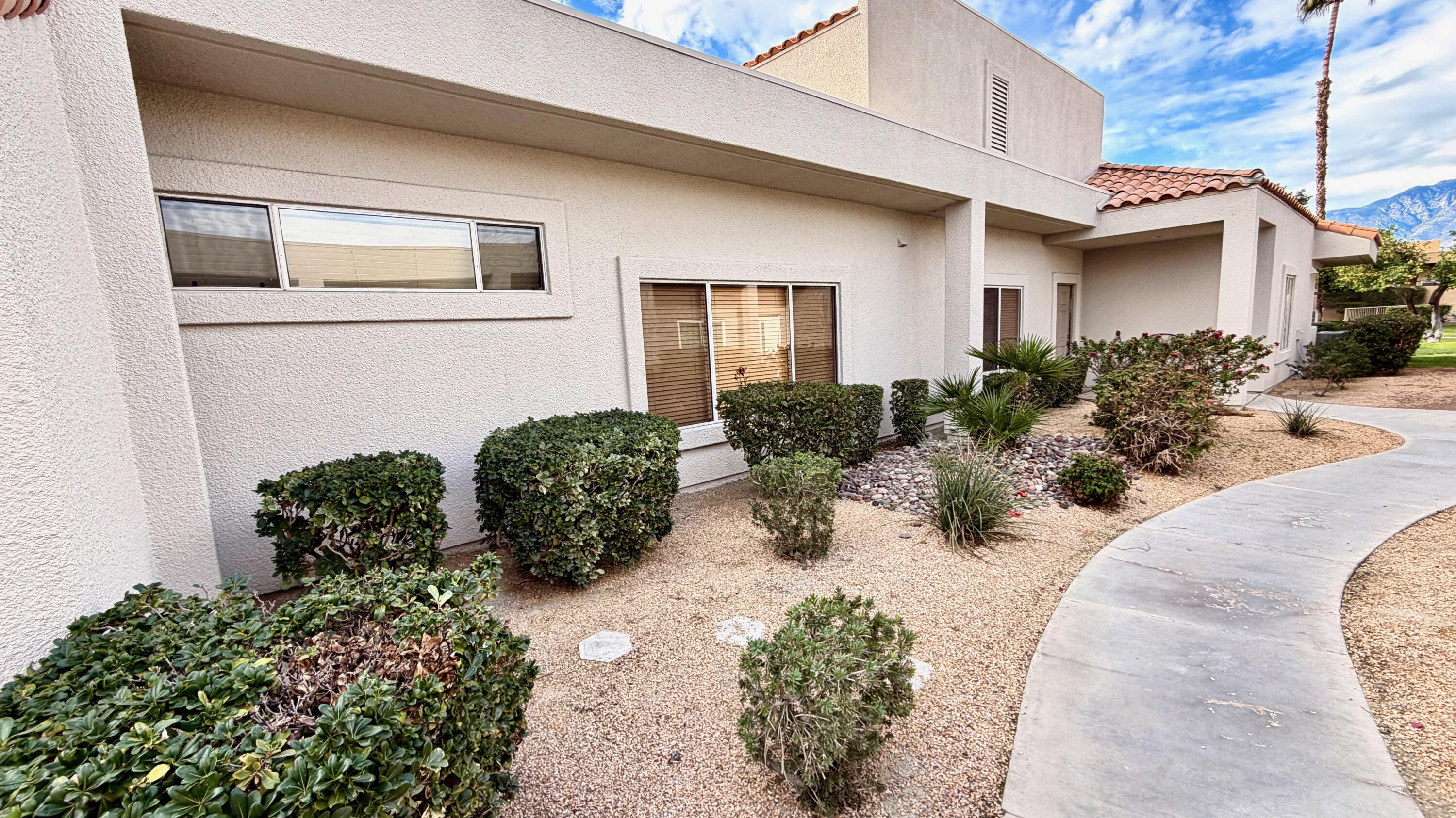 59 Oak Tree Drive Rancho Mirage, CA 92270 - Photo 2 of 22 a view of a house with a yard and plants