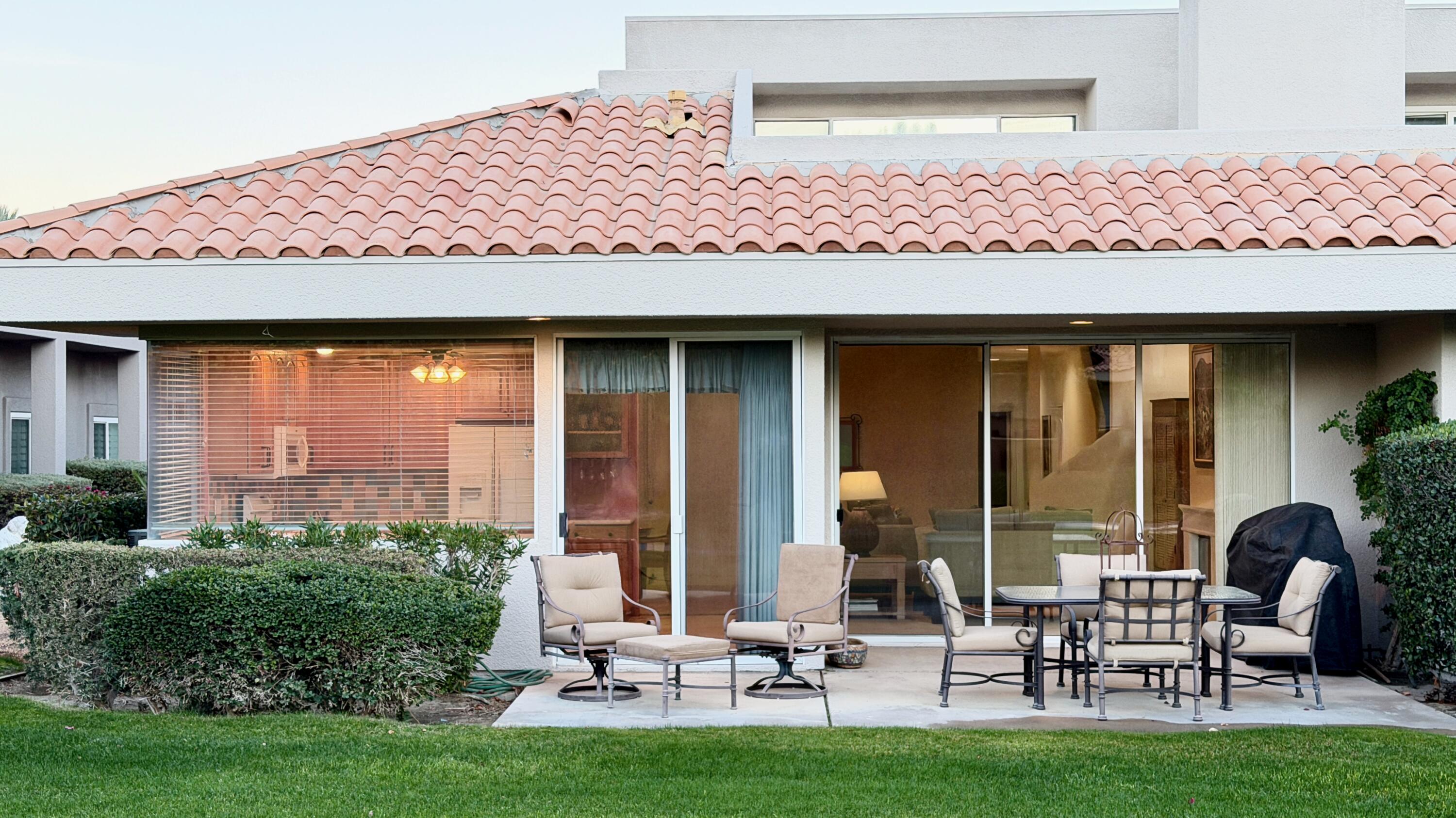 59 Oak Tree Drive Rancho Mirage, CA 92270 - Photo 4 of 22 a view of a chairs and table in backyard