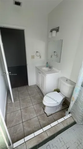 a bathroom with a toilet a sink and bathtub