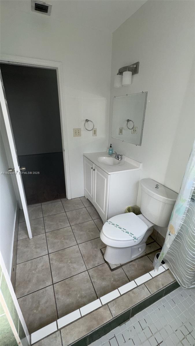 2430 Southwest 25th Terrace, Unit A Miami, FL 33133 - Photo 12 of 19 a bathroom with a toilet a sink and bathtub