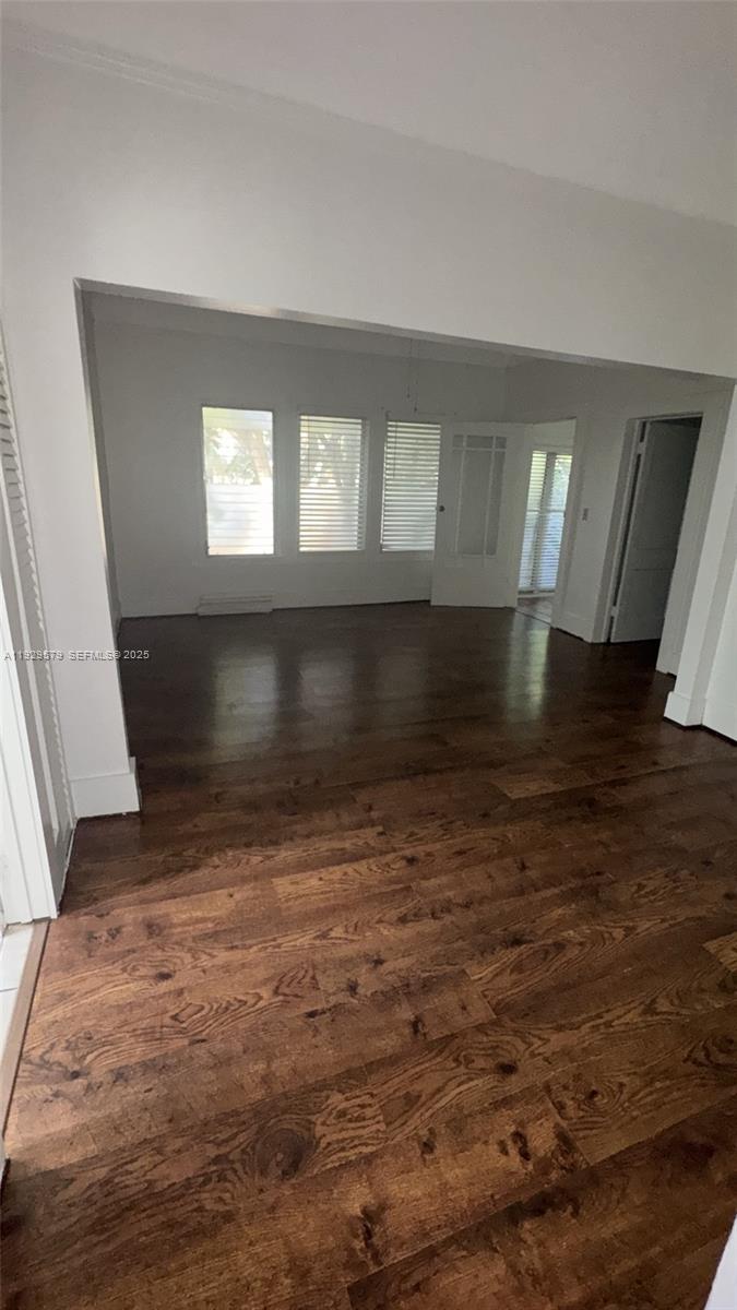 2430 Southwest 25th Terrace, Unit A Miami, FL 33133 - Photo 4 of 19 wooden floor in an empty room with a window