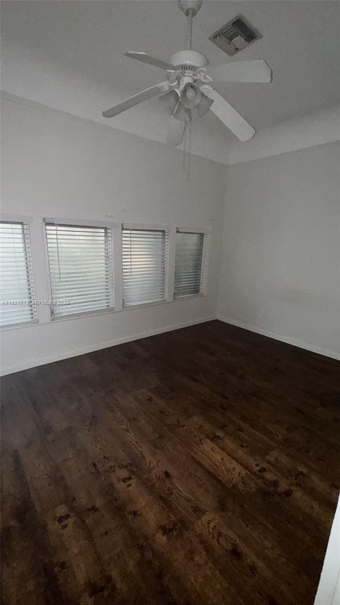 2430 Southwest 25th Terrace, Unit A Miami, FL 33133 - Photo 5 of 19 an empty room with wooden floor and windows