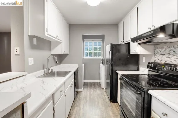 a kitchen with a sink stove and refrigerator
