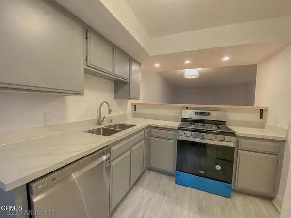 a kitchen with a sink stove and cabinets