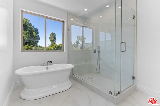 a bathroom with a shower and a sink