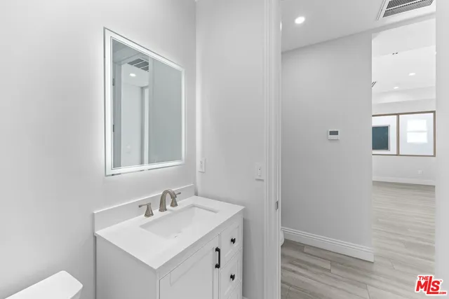 a bathroom with a sink vanity and a mirror