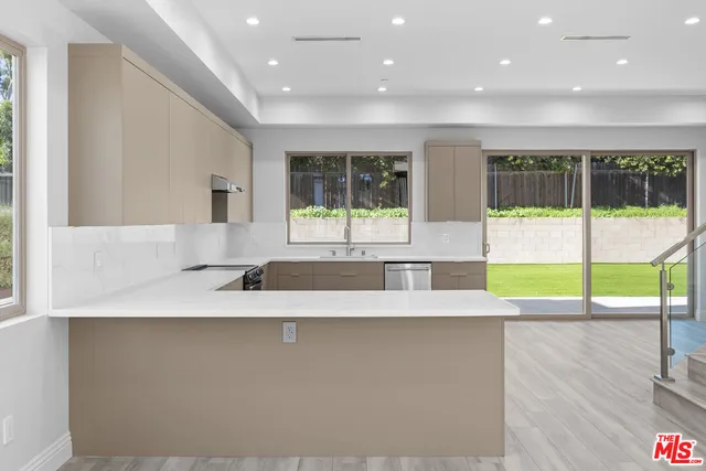 a view of a kitchen with a large window