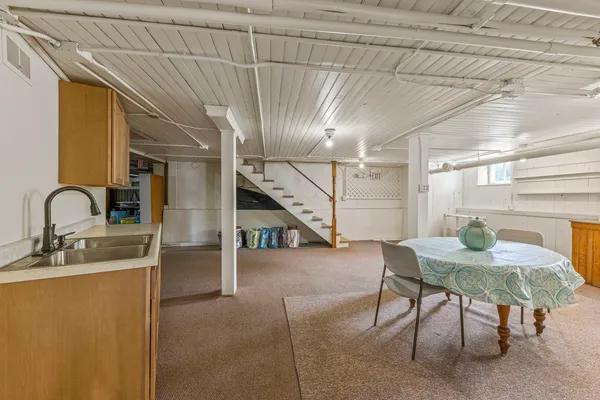 a view of a dining room with furniture and a window