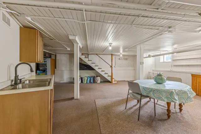 a view of a dining room with furniture and a window