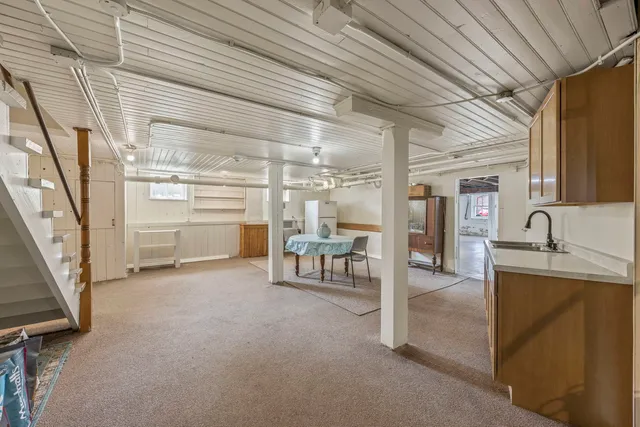 a view of a livingroom with furniture and a window