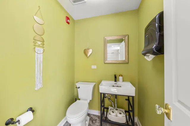 a bathroom with a sink mirror and toilet