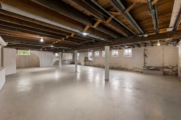 a view of a room with wooden floors