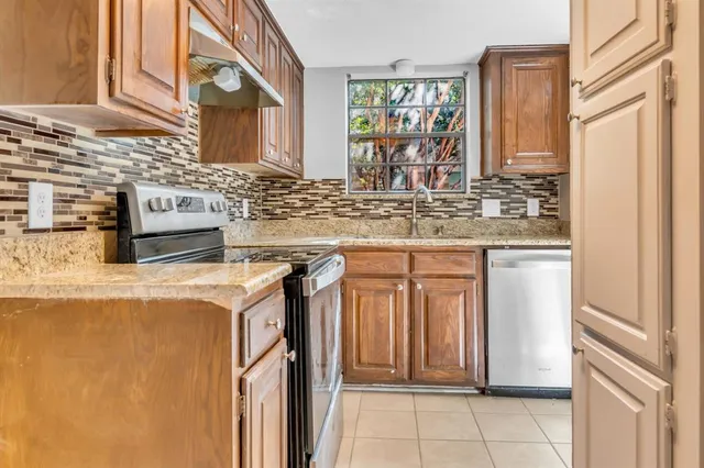 a bathroom with a granite countertop toilet and sink