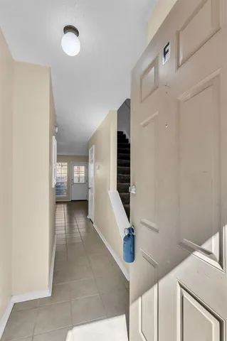 a view of entryway and hall with wooden floor