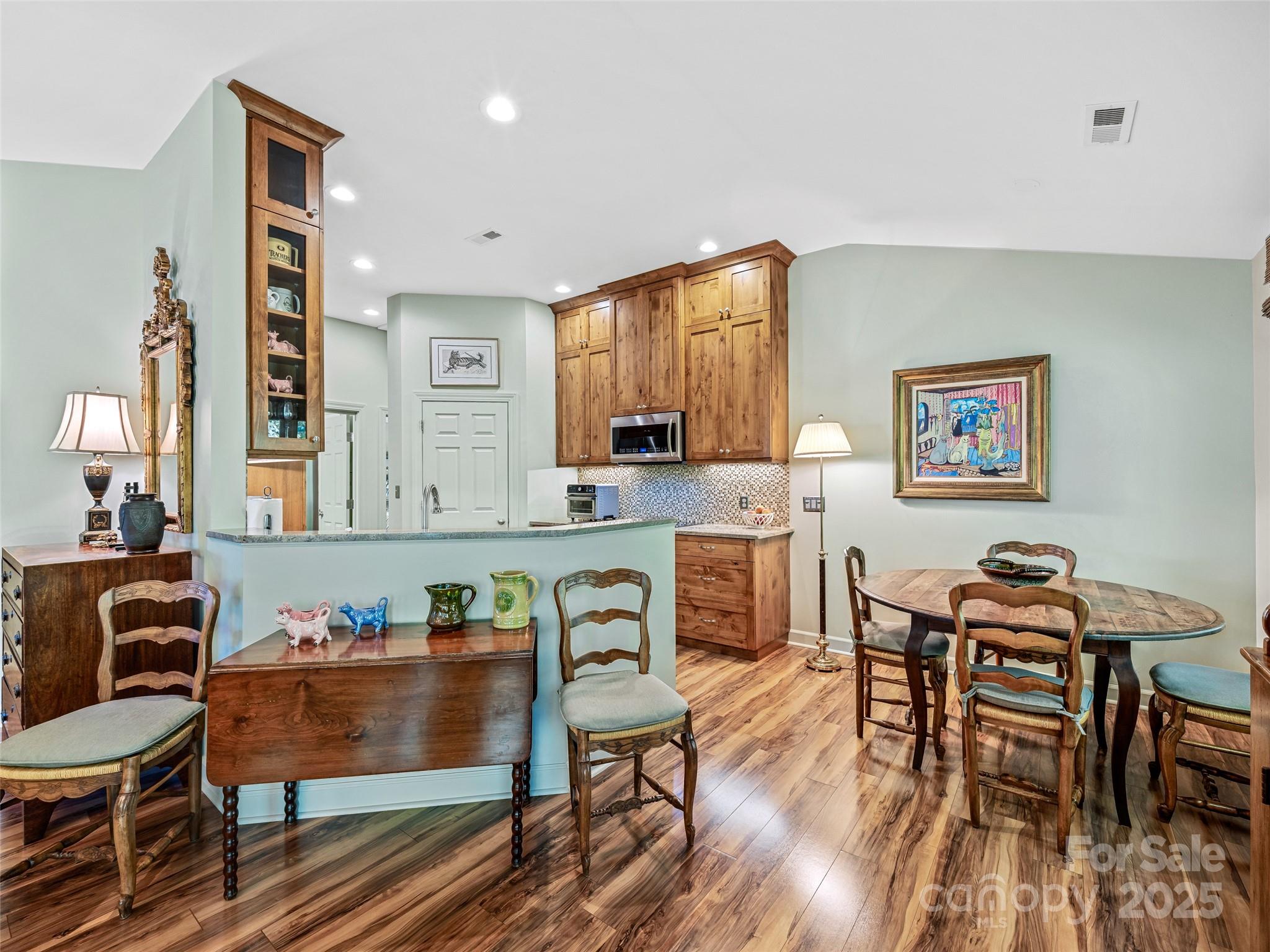 73 Ridgetop Circle, Unit 303 Brevard, NC 28712 - Photo 11 of 28 a view of a dining room with furniture window and wooden floor