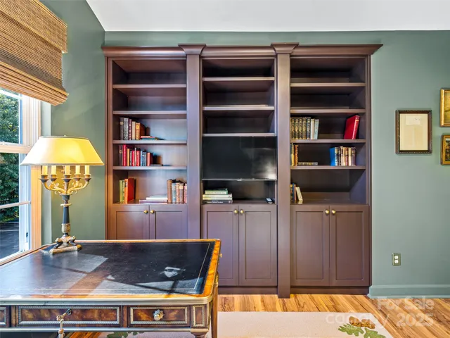 a living room with furniture and a bookshelf