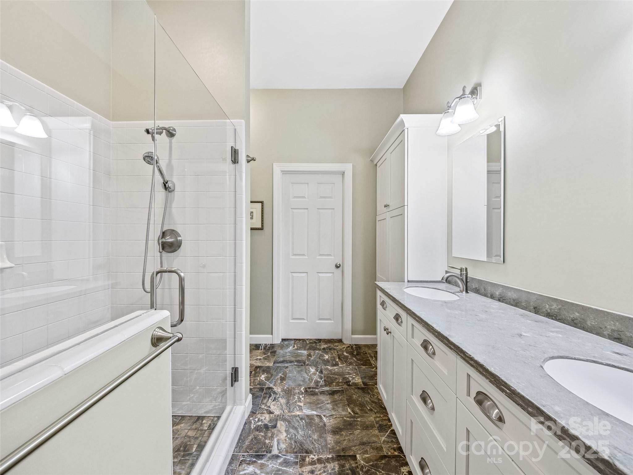 73 Ridgetop Circle, Unit 303 Brevard, NC 28712 - Photo 24 of 28 a bathroom with a granite countertop tub sink and mirror