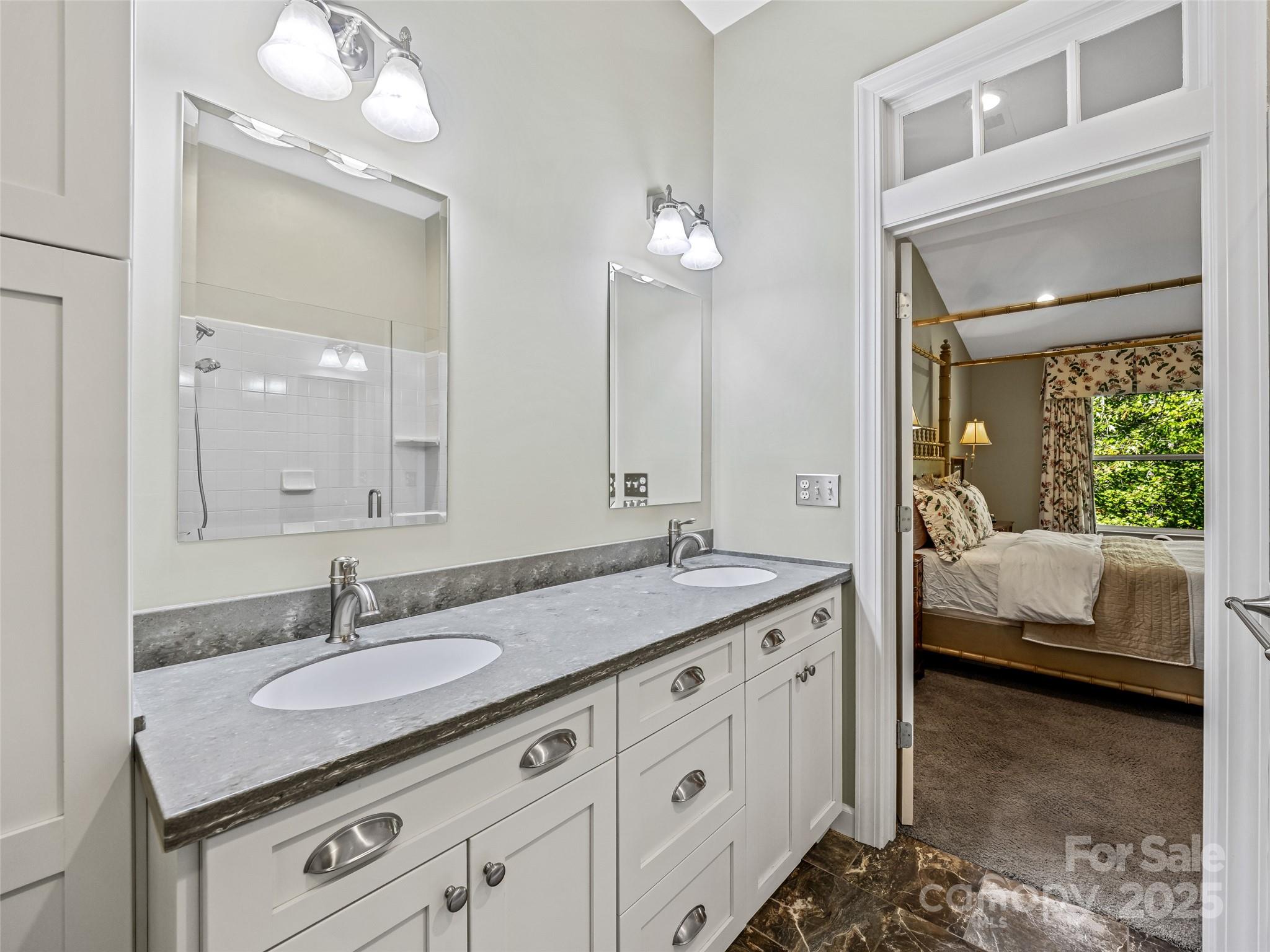73 Ridgetop Circle, Unit 303 Brevard, NC 28712 - Photo 25 of 28 a en suite bathroom with a granite countertop sink and a mirror