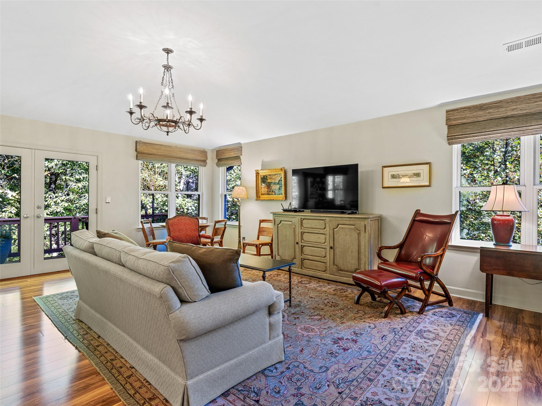 73 Ridgetop Circle, Unit 303 Brevard, NC 28712 - Photo 7 of 28 a living room with furniture and a flat screen tv