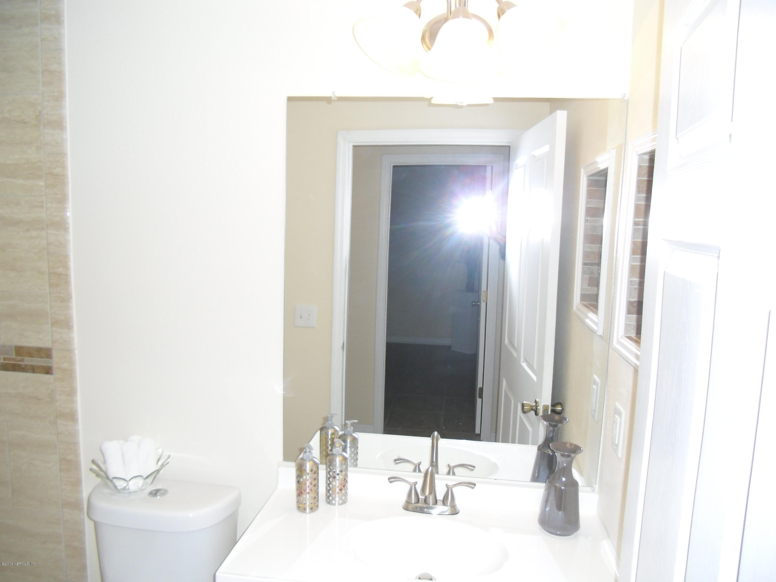 4221 Spring Park Road Jacksonville, FL 32207 - Photo 40 of 56 a bathroom with a sink and a mirror