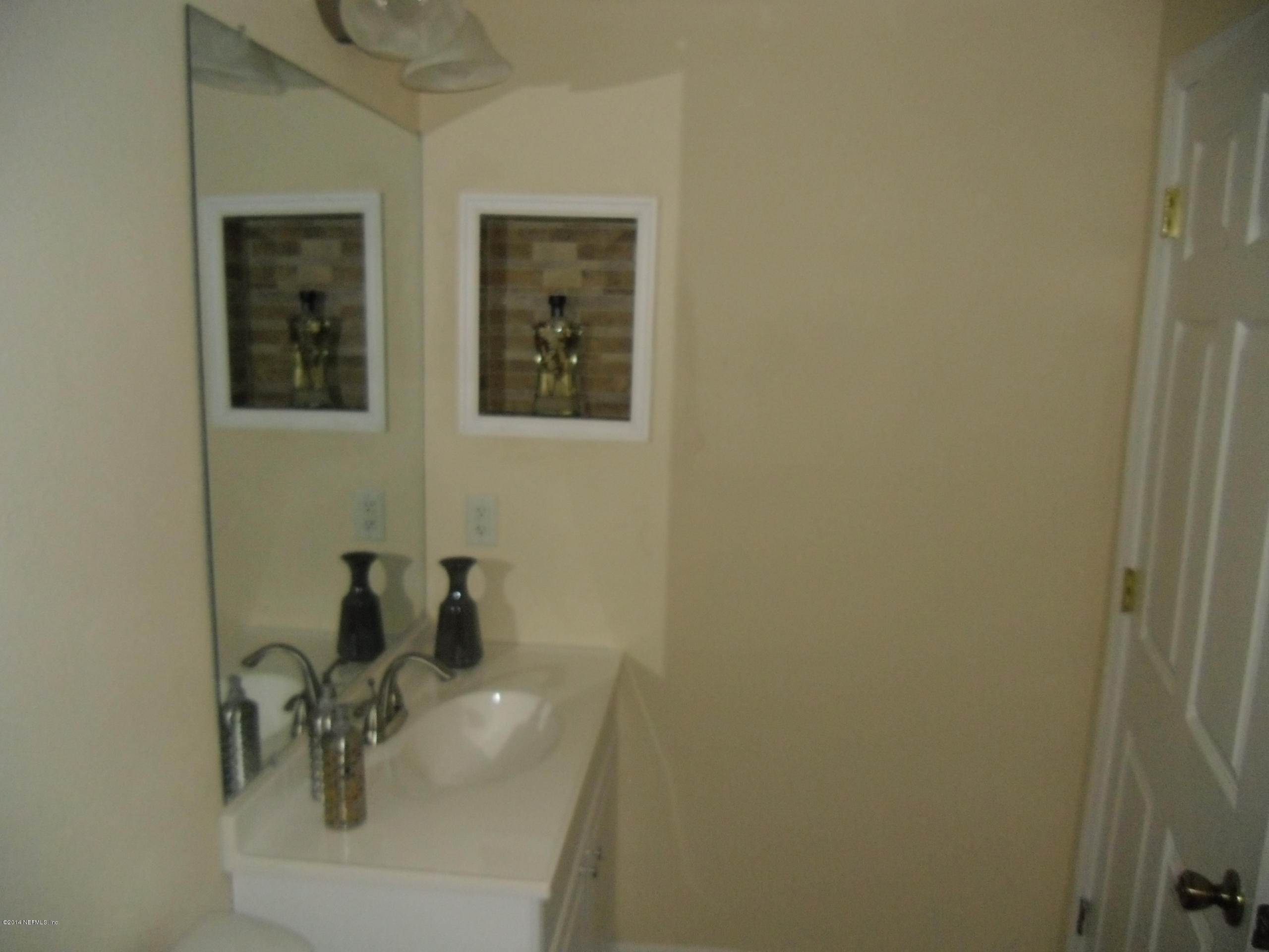 4221 Spring Park Road Jacksonville, FL 32207 - Photo 42 of 56 a bathroom with a sink and a mirror