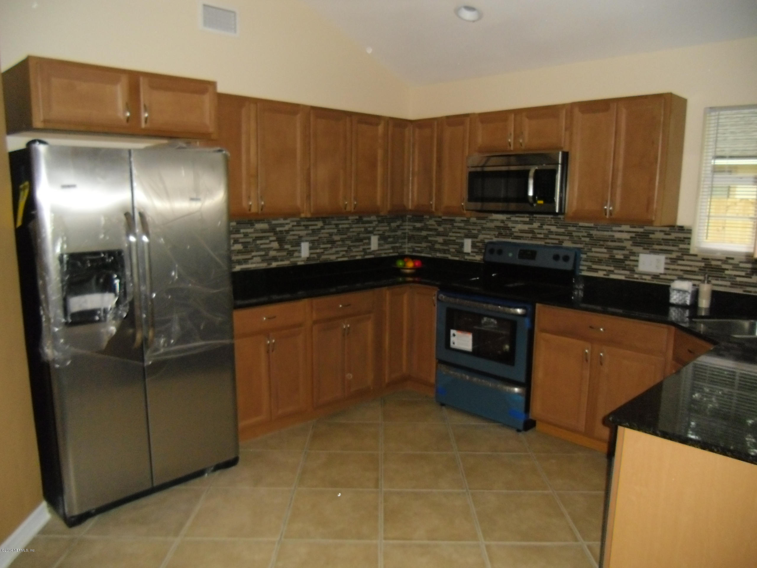 4221 Spring Park Road Jacksonville, FL 32207 - Photo 7 of 56 a kitchen with stainless steel appliances granite countertop a stove and a refrigerator