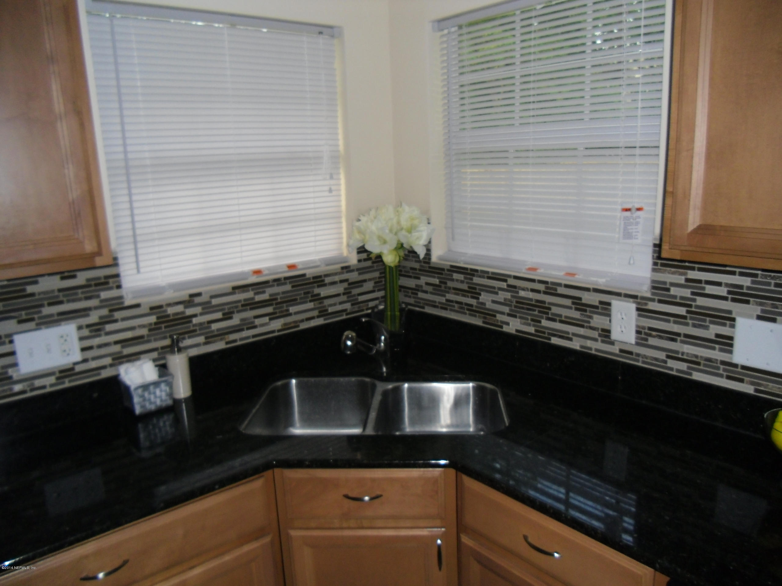 4221 Spring Park Road Jacksonville, FL 32207 - Photo 9 of 56 a kitchen with a sink and cabinets