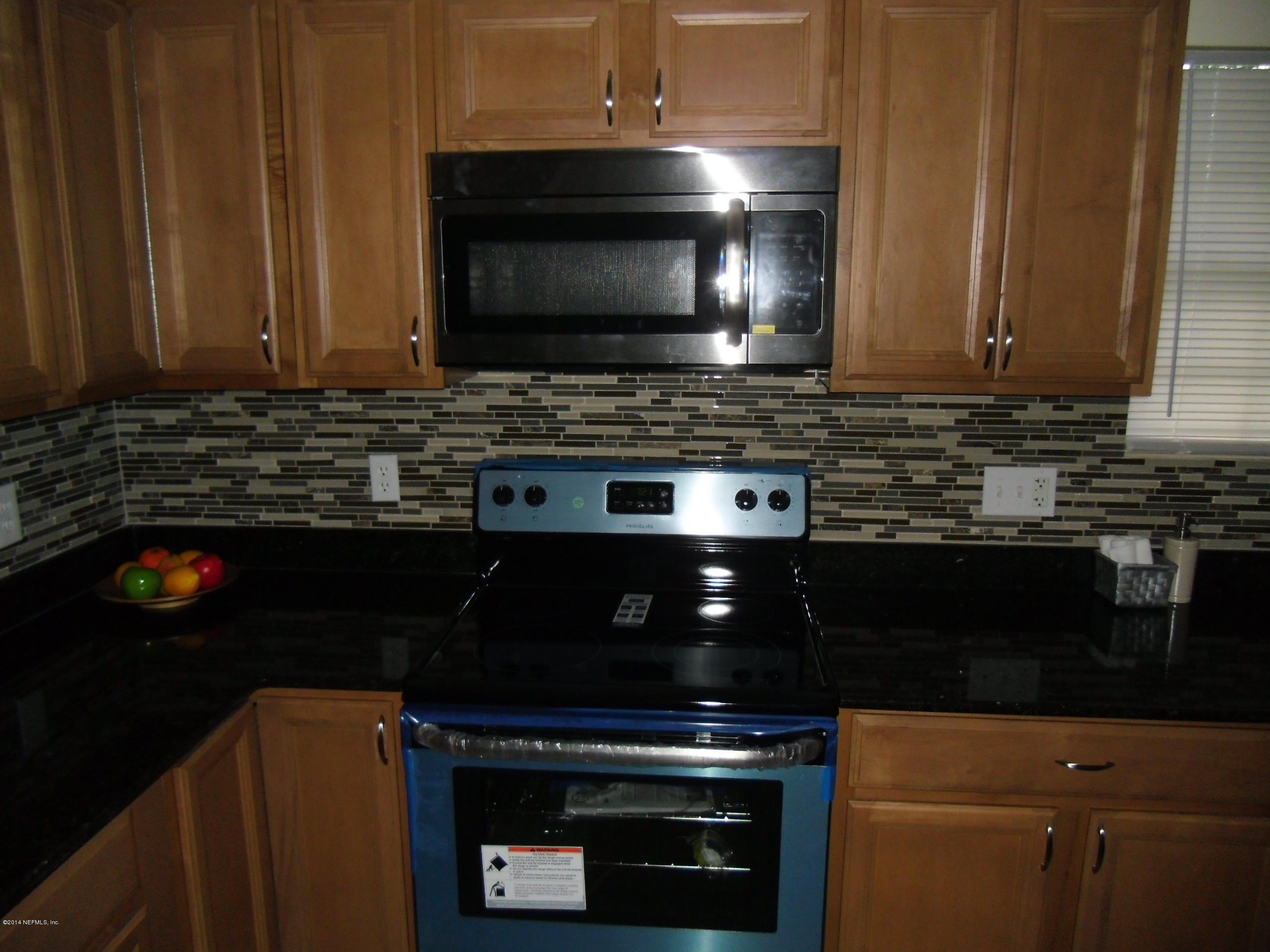 4221 Spring Park Road Jacksonville, FL 32207 - Photo 10 of 56 a kitchen with a stove and a microwave
