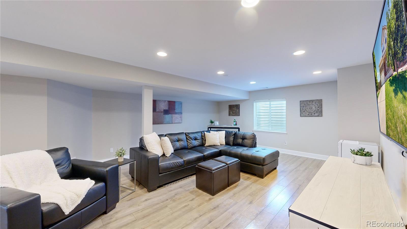 5759 Canyon Circle Longmont, CO 80504 - Photo 20 of 37 a living room with furniture and a wooden floor