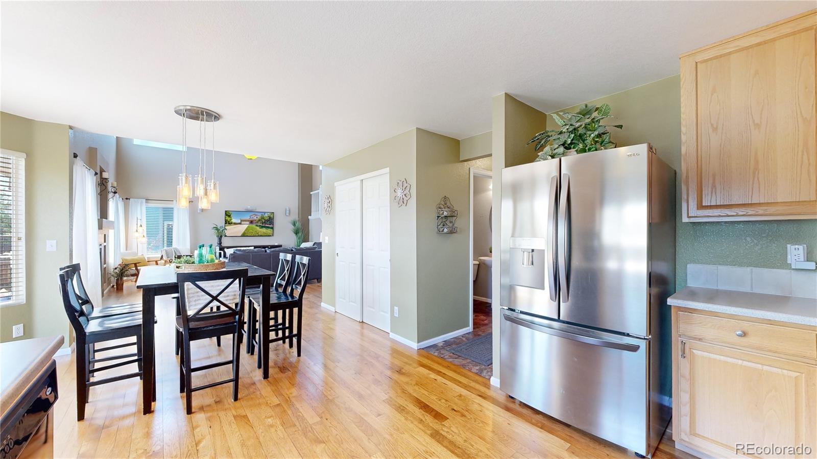 5759 Canyon Circle Longmont, CO 80504 - Photo 10 of 37 a kitchen with stainless steel appliances a refrigerator a stove a dining table and chairs