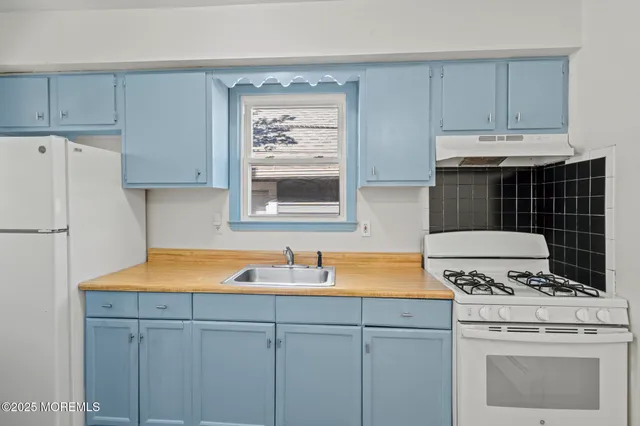 a kitchen with a sink cabinets and appliances
