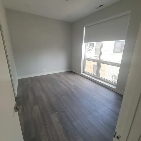 a view of storage and utility room with wooden floor