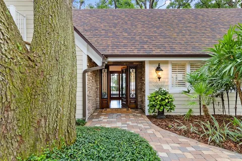 a very nice looking living room with a large window and wooden floor