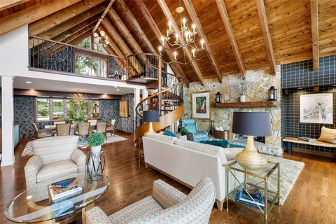 a spacious bedroom with a bed and wooden floor