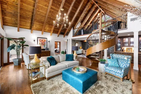 a living room with a couch and a projector with wooden floor