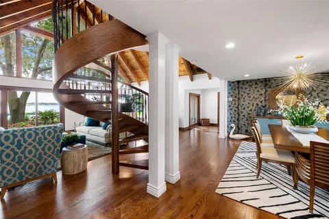 a bedroom with a bed mirror and window